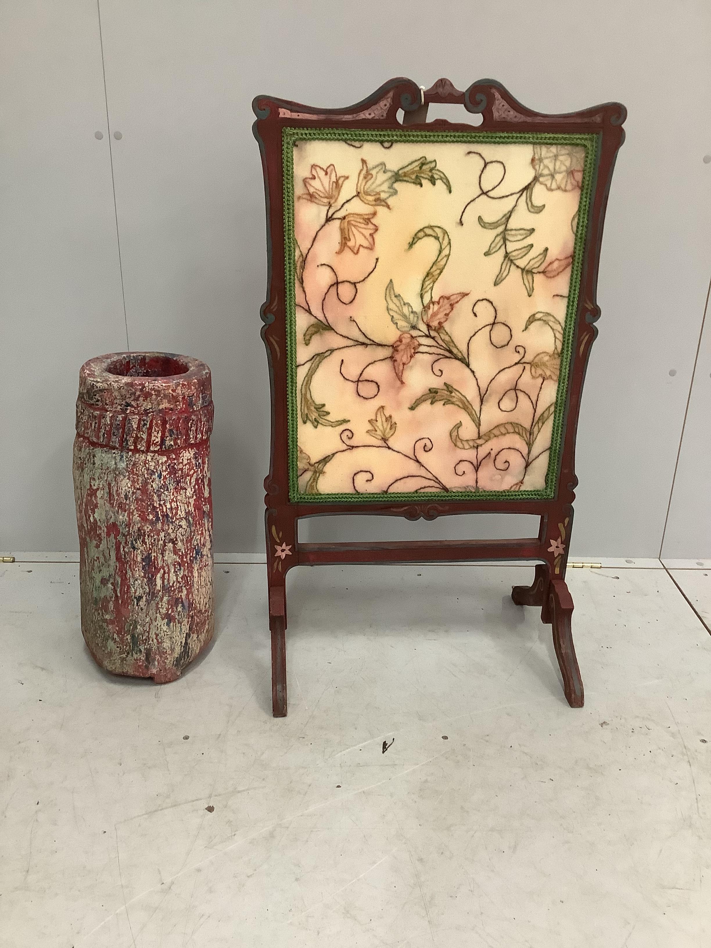 An African painted wood mortar together with a painted firescreen, height 102cm